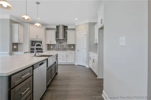 a kitchen with a sink dishwasher a stove and a refrigerator
