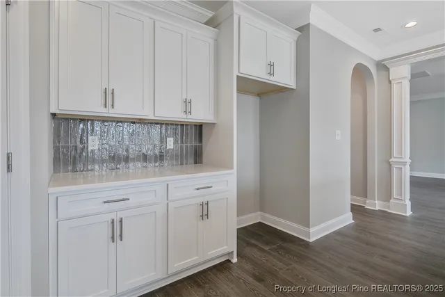 a kitchen with white cabinets and a sink