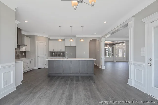 a large kitchen with a lot of counter space and a refrigerator
