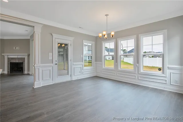 an empty room with chandelier and windows