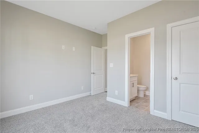 a bathroom with a toilet a sink and vanity