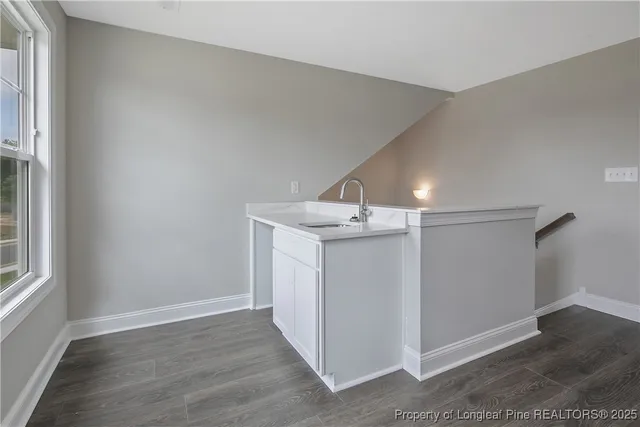 a bathroom with a granite countertop sink a mirror and a bathtub