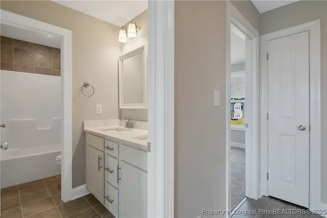 a bathroom with a shower sink and mirror