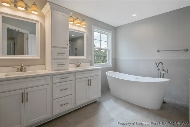 a bathroom with a double vanity sink a window and a mirror