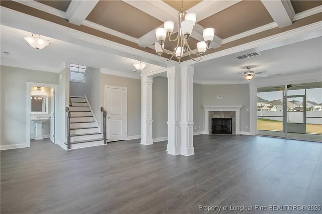a view of a livingroom with a fireplace wooden floor and staircase