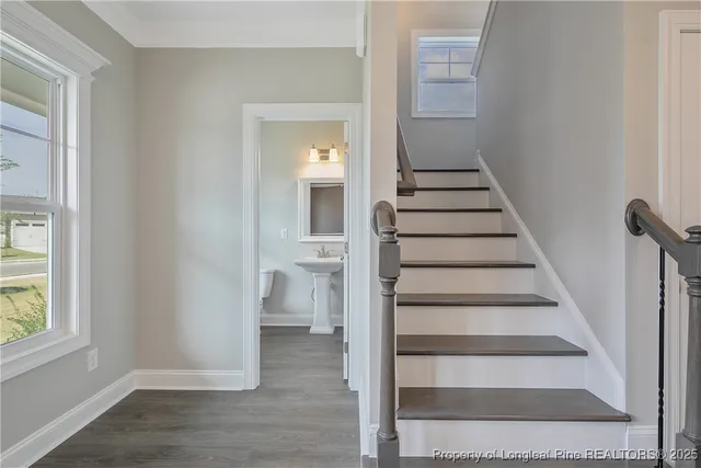 a view of entryway and hall with wooden floor