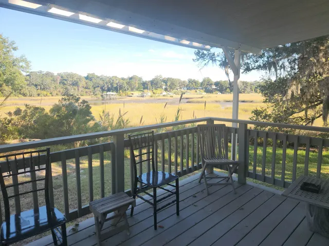a view of a balcony with lake view and wooden floor