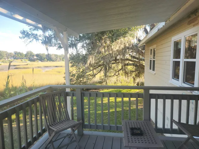 a view of a balcony with lake view and wooden floor