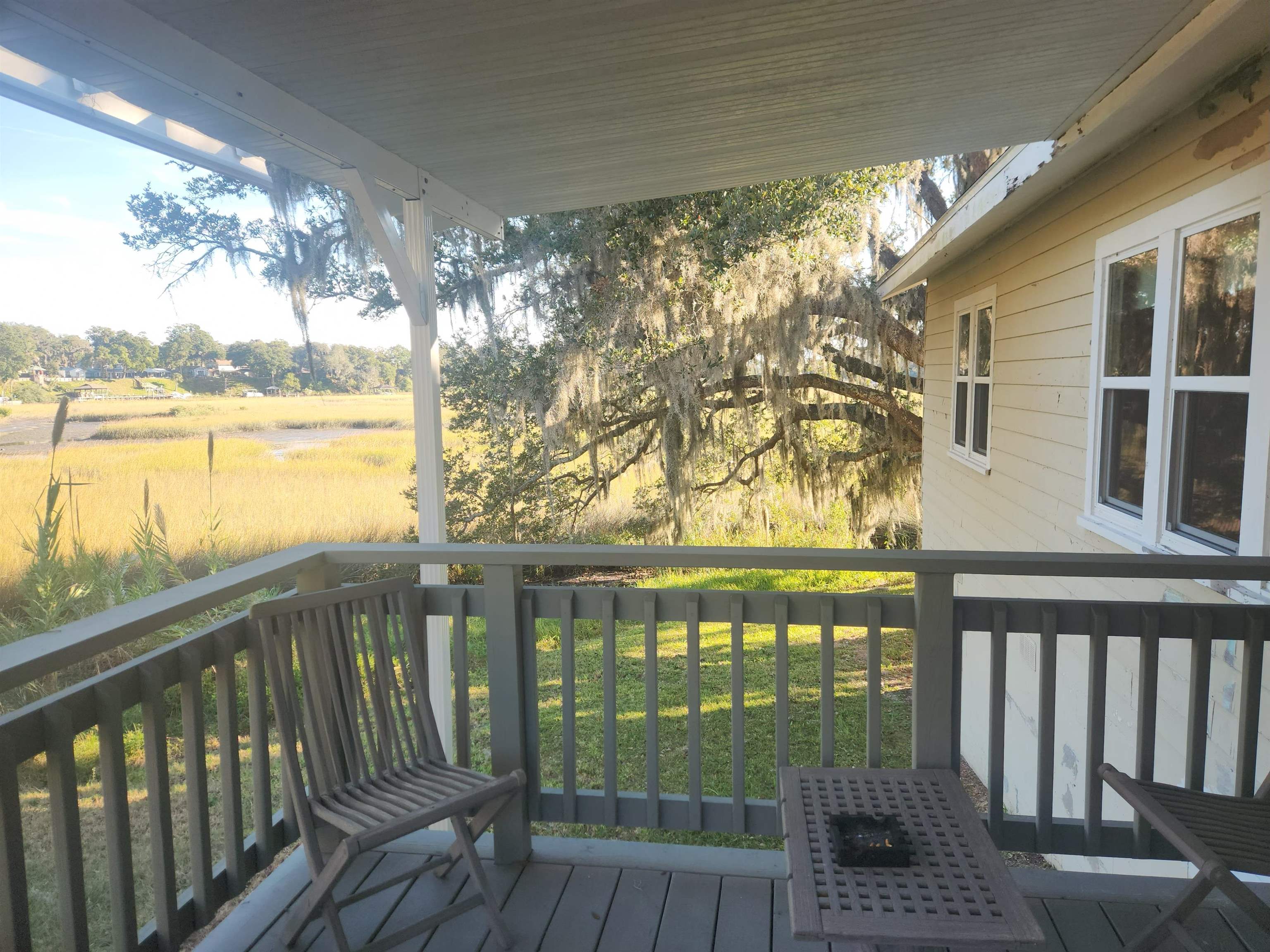 250 Brainard Drive, Unit A St. Augustine, FL 32086 - Photo 2 of 13 a view of a balcony with lake view and wooden floor