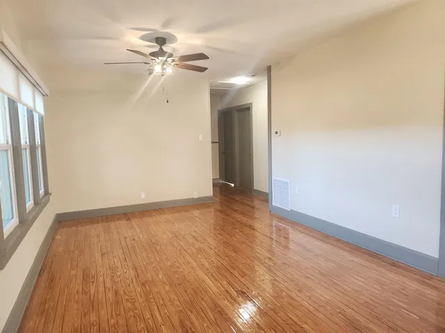 wooden floor in an empty room with a window