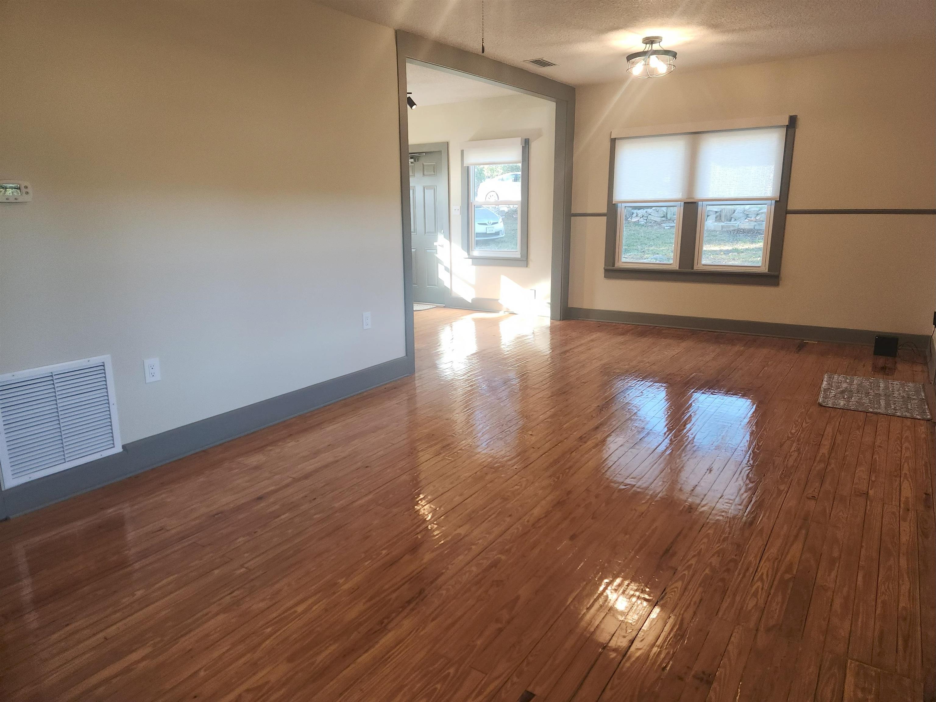 250 Brainard Drive, Unit A St. Augustine, FL 32086 - Photo 8 of 13 wooden floor in an empty room with a window