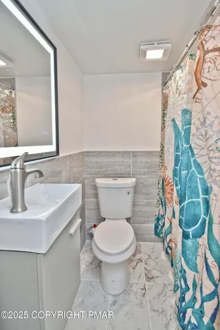 a bathroom with a toilet sink and shower