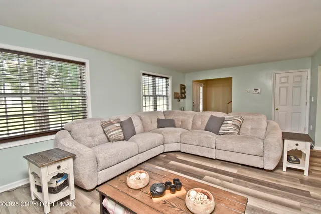 a living room with furniture and a large window