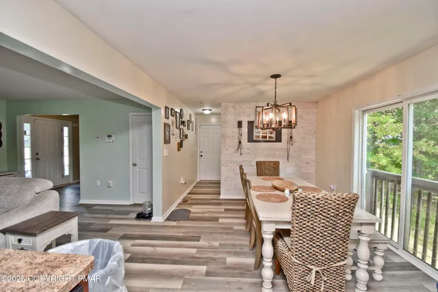 a living room with furniture a window and a chandelier