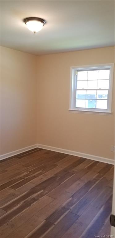 4226 Colebrook Road Charlotte, NC 28215 - Photo 11 of 11 an empty room with wooden floor and windows