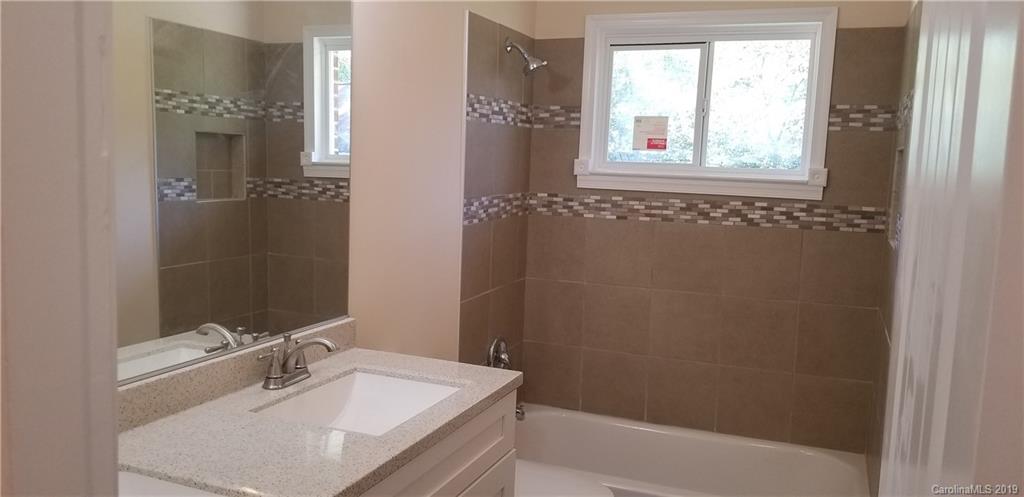 4226 Colebrook Road Charlotte, NC 28215 - Photo 6 of 11 a bathroom with a sink and a mirror
