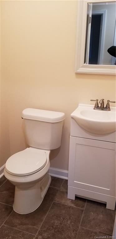 4226 Colebrook Road Charlotte, NC 28215 - Photo 8 of 11 a white toilet sitting next to a bathroom sink