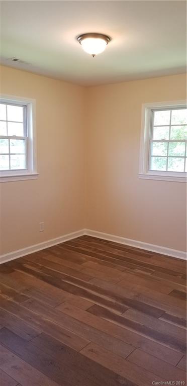 4226 Colebrook Road Charlotte, NC 28215 - Photo 9 of 11 an empty room with wooden floor and windows