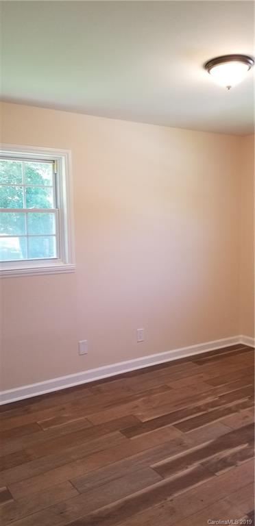 4226 Colebrook Road Charlotte, NC 28215 - Photo 10 of 11 an empty room with wooden floor and windows