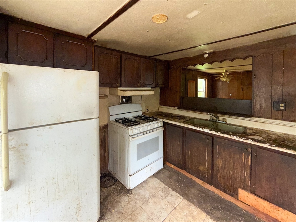 594 Route 8A Heath, MA 01340 - Photo 9 of 14 a kitchen with a refrigerator sink stove and cabinets