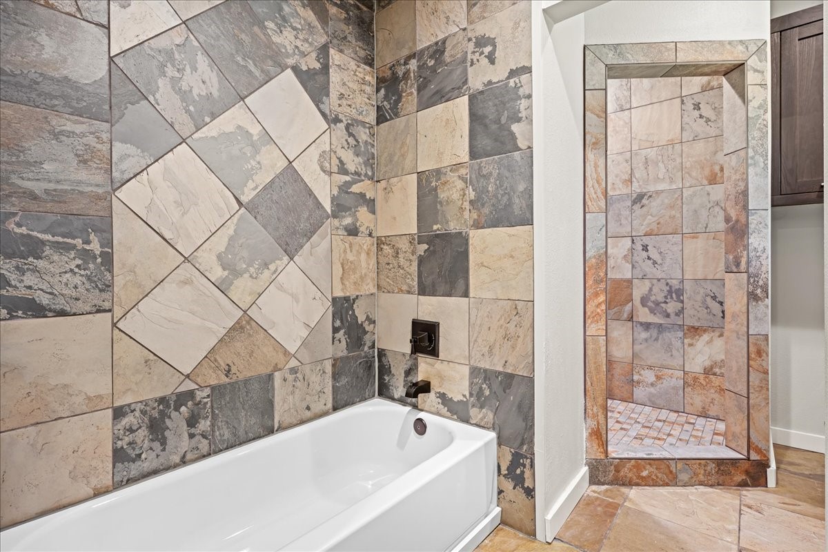 1502 Reimer Street Brenham, TX 77833 - Photo 23 of 30 a bathroom with a bathtub and shower