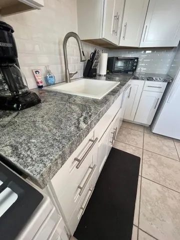 a kitchen with a stove and a sink