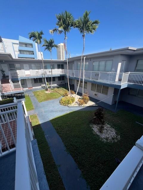 350 75th Street, Unit 202 Miami Beach, FL 33141 - Photo 20 of 21 a view of a backyard with plants and swimming pool