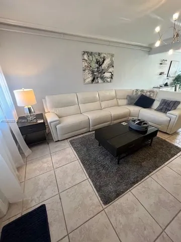 a living room with furniture and a rug