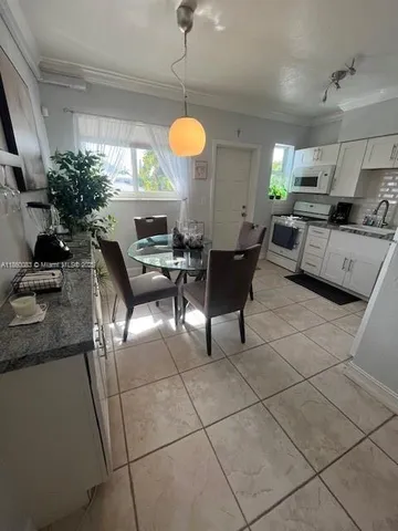 a living room with couches a fireplace and a potted plant