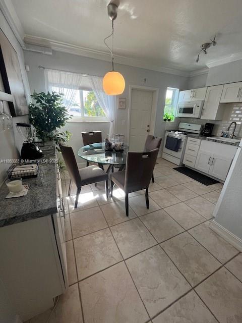350 75th Street, Unit 202 Miami Beach, FL 33141 - Photo 9 of 21 a living room with couches a fireplace and a potted plant