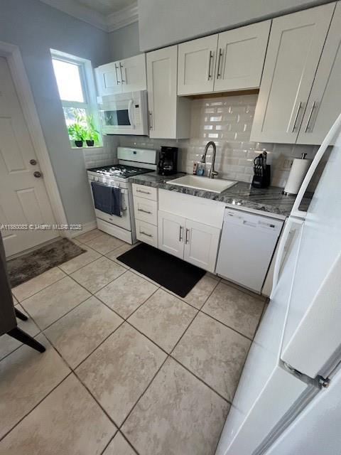 350 75th Street, Unit 202 Miami Beach, FL 33141 - Photo 10 of 21 a kitchen with stainless steel appliances kitchen island granite countertop a sink a stove a microwave a sink a counter space and cabinets