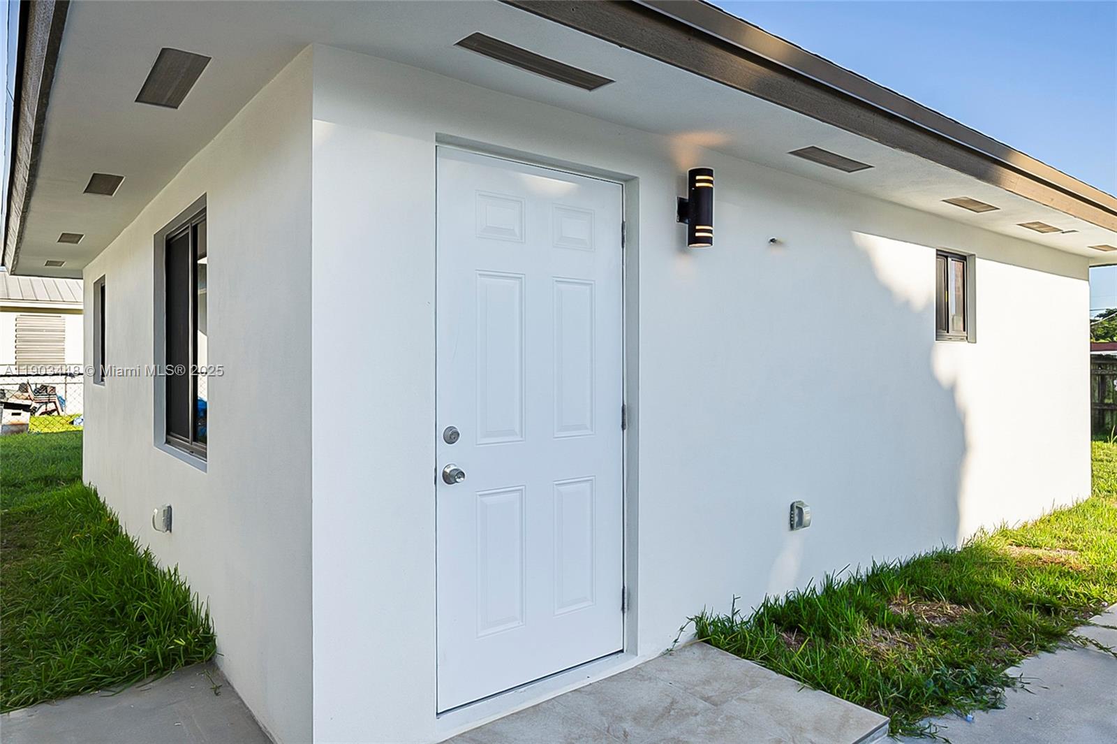 10362 Southwest 180th Street, Unit 3 Miami, FL 33157 - Photo 2 of 17 a view of a hallway with wooden walls and windows