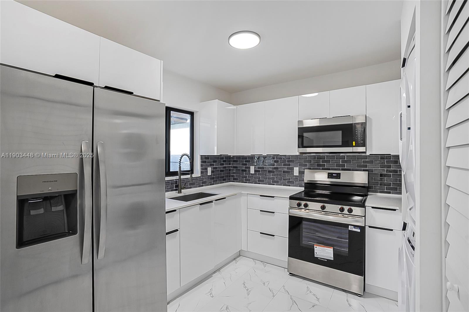 10362 Southwest 180th Street, Unit 3 Miami, FL 33157 - Photo 5 of 17 a kitchen with cabinets stainless steel appliances and a counter space
