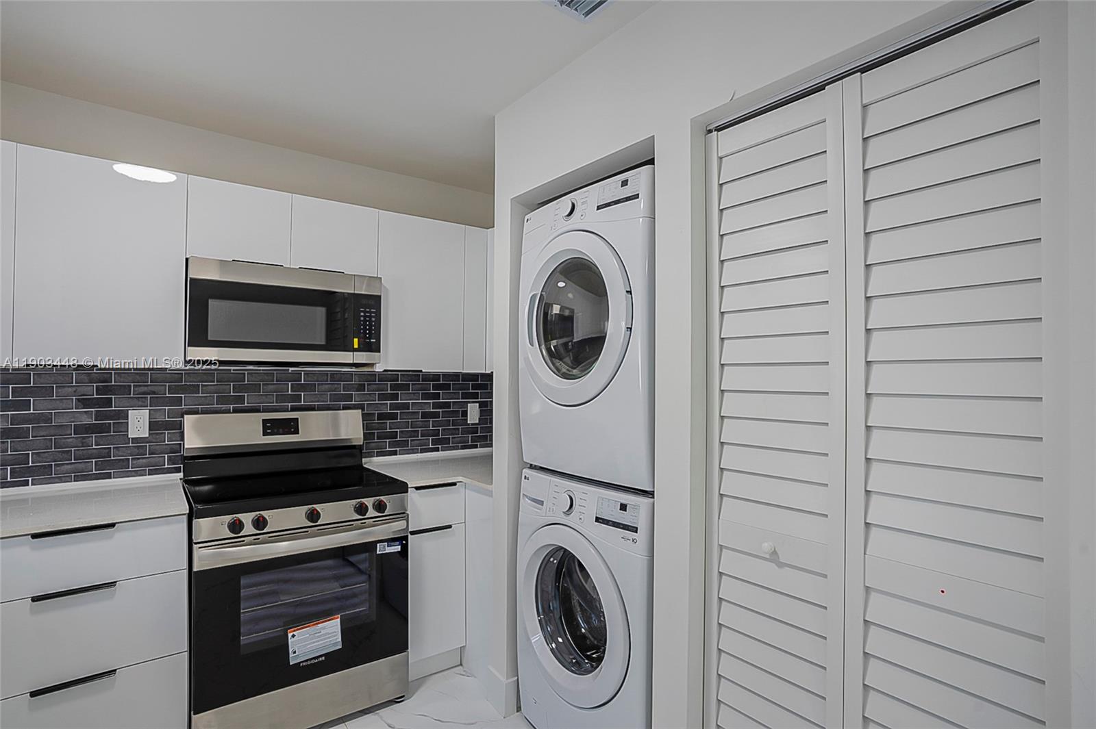 10362 Southwest 180th Street, Unit 3 Miami, FL 33157 - Photo 6 of 17 a kitchen with a stove and a microwave