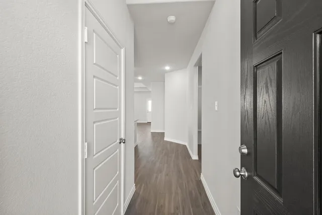 a view of a hallway with wooden floor