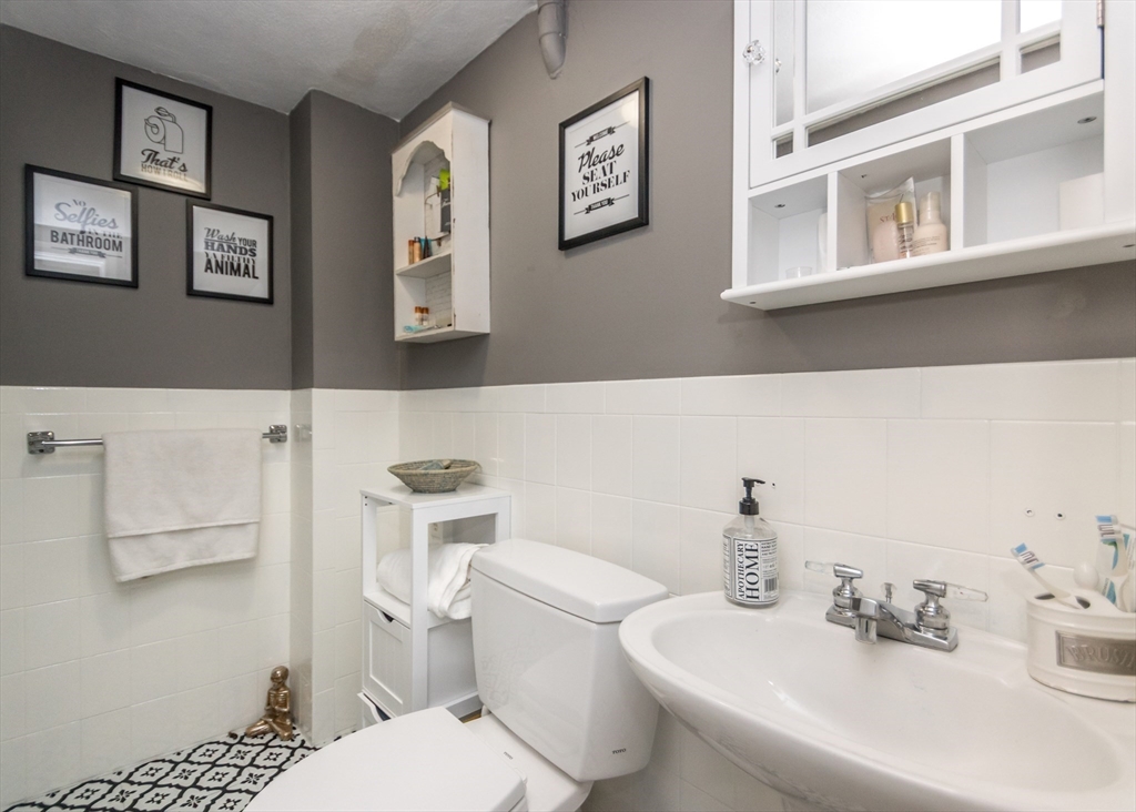 27 Sherman Street Needham, MA 02494 - Photo 25 of 32 a bathroom with a toilet sink and mirror