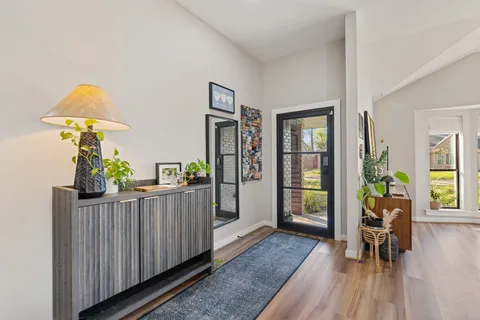a living room with furniture and a wooden floor