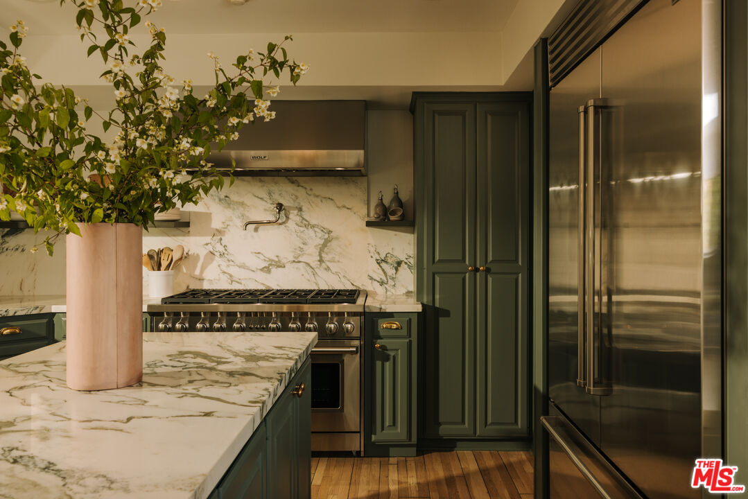 2610 Mandeville Canyon Road Los Angeles, CA 90049 - Photo 14 of 32 a kitchen with a stove and a refrigerator