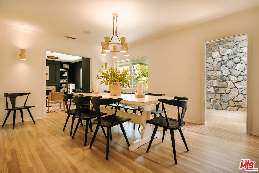2610 Mandeville Canyon Road Los Angeles, CA 90049 - Photo 17 of 32 a view of a dining room with furniture and wooden floor