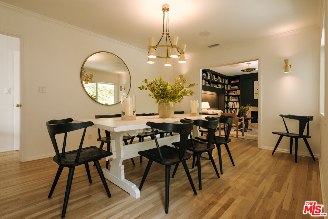 2610 Mandeville Canyon Road Los Angeles, CA 90049 - Photo 18 of 32 a view of a dining room with furniture and wooden floor