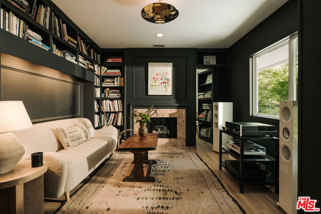 2610 Mandeville Canyon Road Los Angeles, CA 90049 - Photo 19 of 32 a living room with furniture a rug and a large window