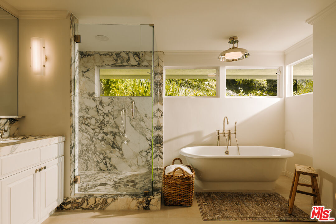 2610 Mandeville Canyon Road Los Angeles, CA 90049 - Photo 23 of 32 a bathroom with a sink and a mirror