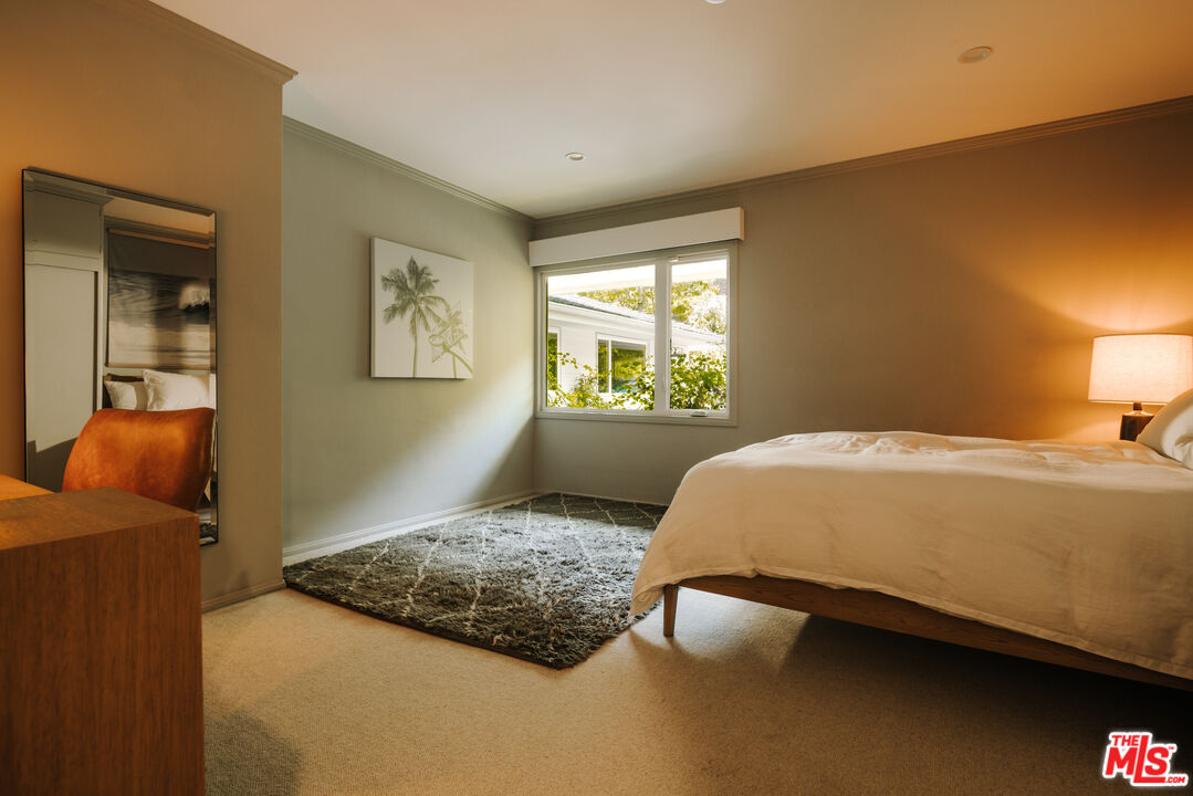 2610 Mandeville Canyon Road Los Angeles, CA 90049 - Photo 27 of 32 a bedroom with a bed and window