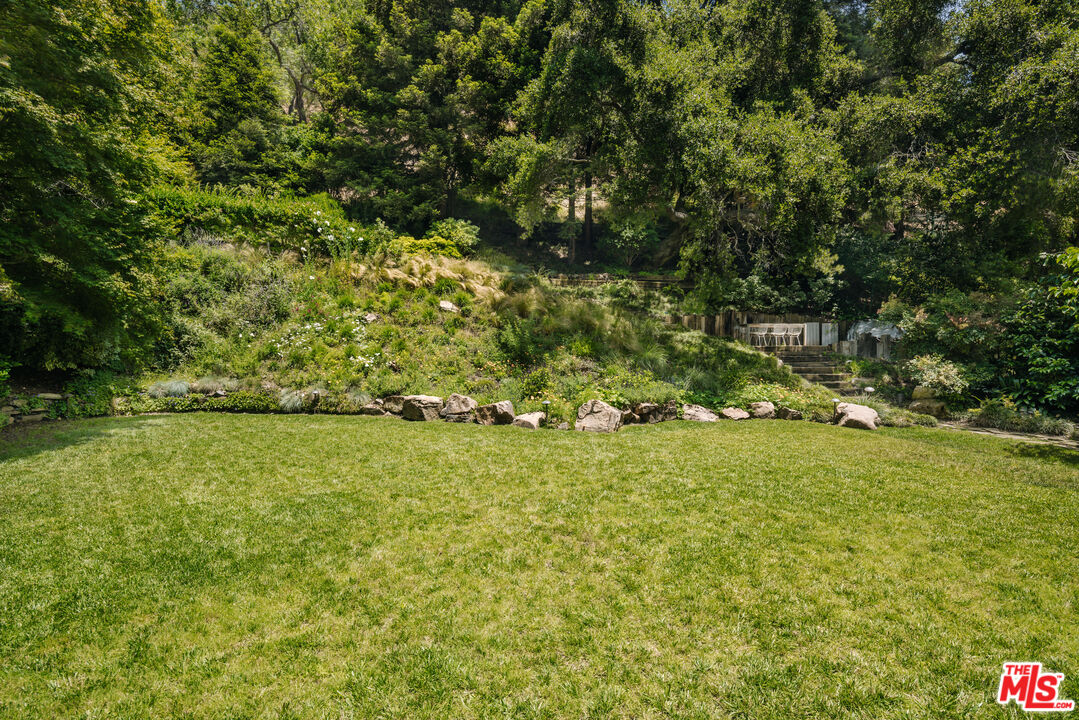 2610 Mandeville Canyon Road Los Angeles, CA 90049 - Photo 29 of 32 a view of yard with green space