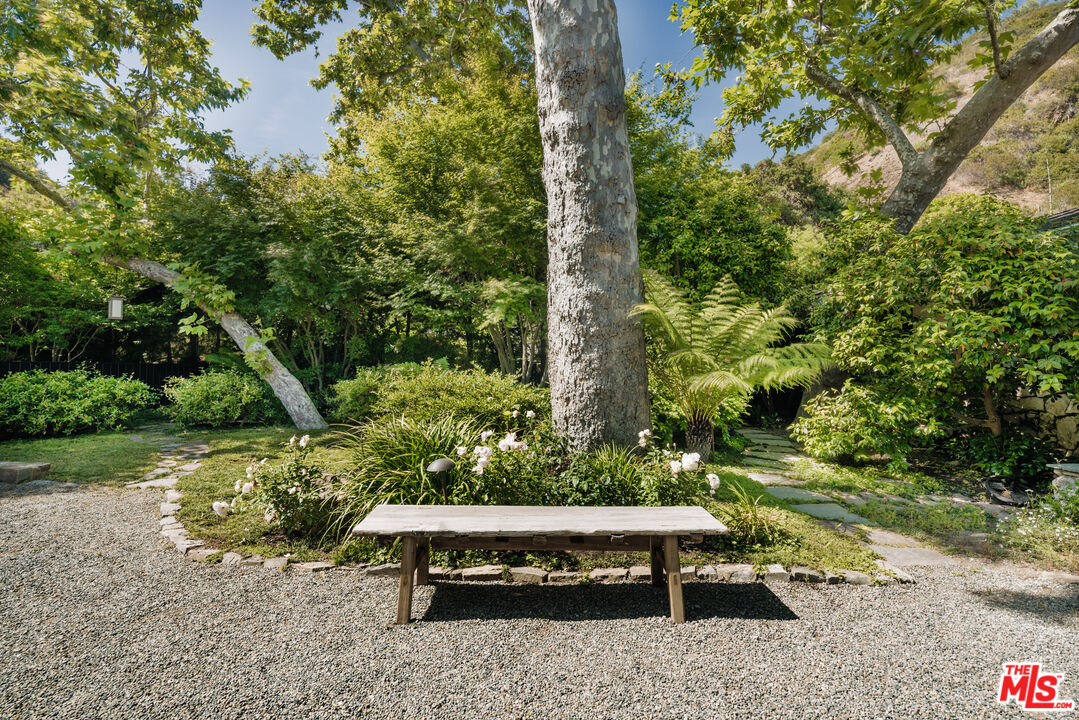 2610 Mandeville Canyon Road Los Angeles, CA 90049 - Photo 31 of 32 a view of a bench in the garden