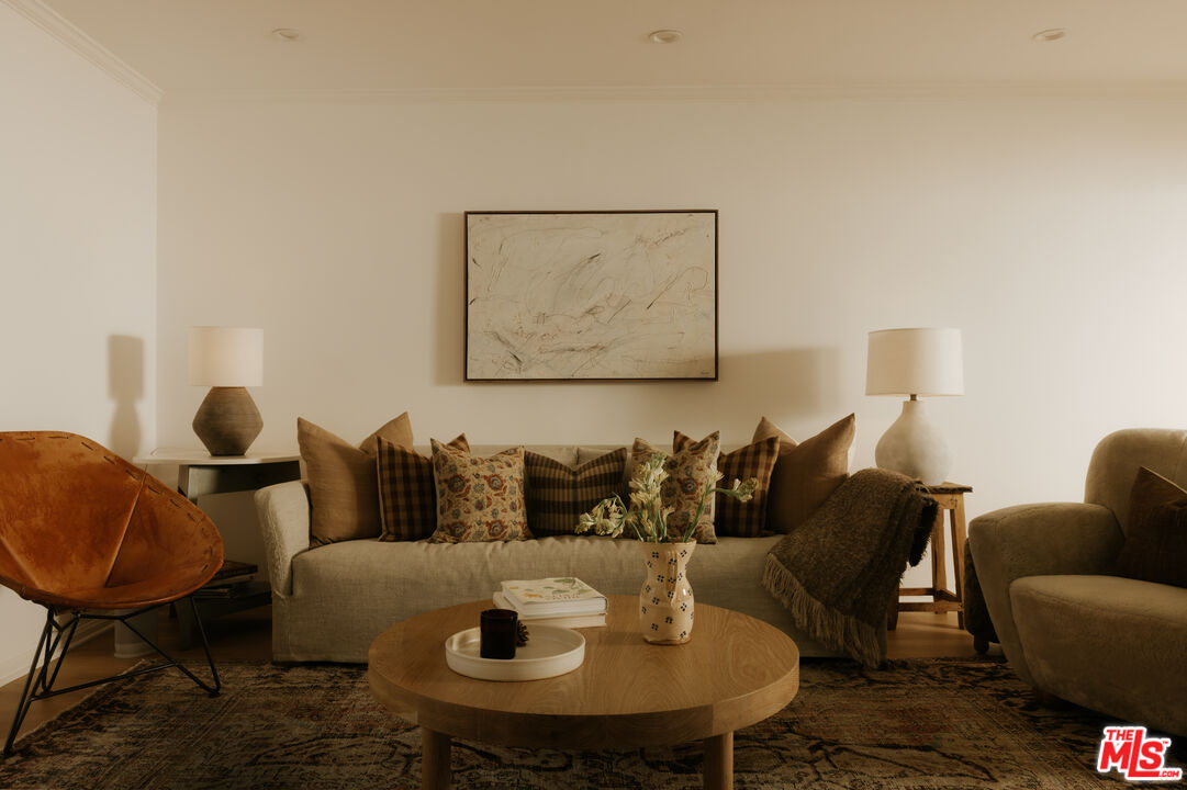 2610 Mandeville Canyon Road Los Angeles, CA 90049 - Photo 6 of 32 a living room with furniture and a lamp