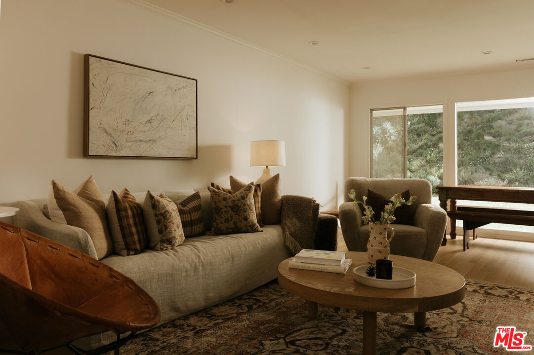 2610 Mandeville Canyon Road Los Angeles, CA 90049 - Photo 7 of 32 a living room with furniture and a large window