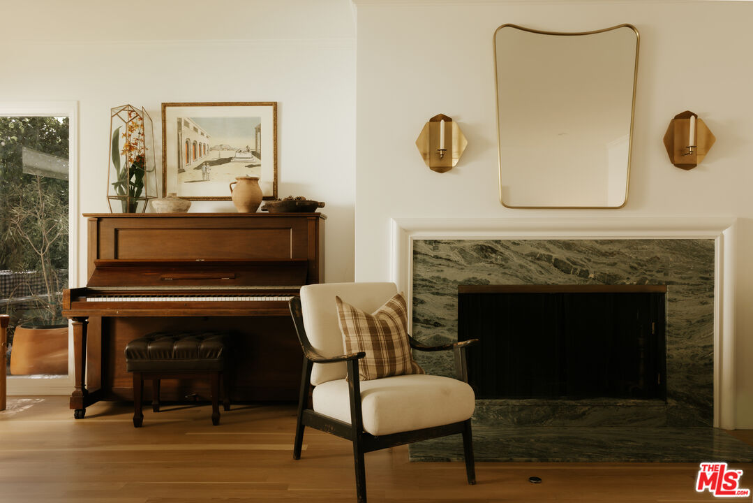 2610 Mandeville Canyon Road Los Angeles, CA 90049 - Photo 9 of 32 a living room with furniture and a fireplace