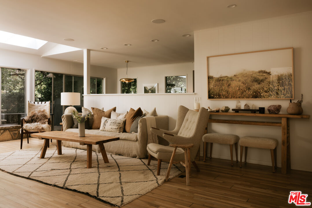 2610 Mandeville Canyon Road Los Angeles, CA 90049 - Photo 10 of 32 a living room with furniture and wooden floor