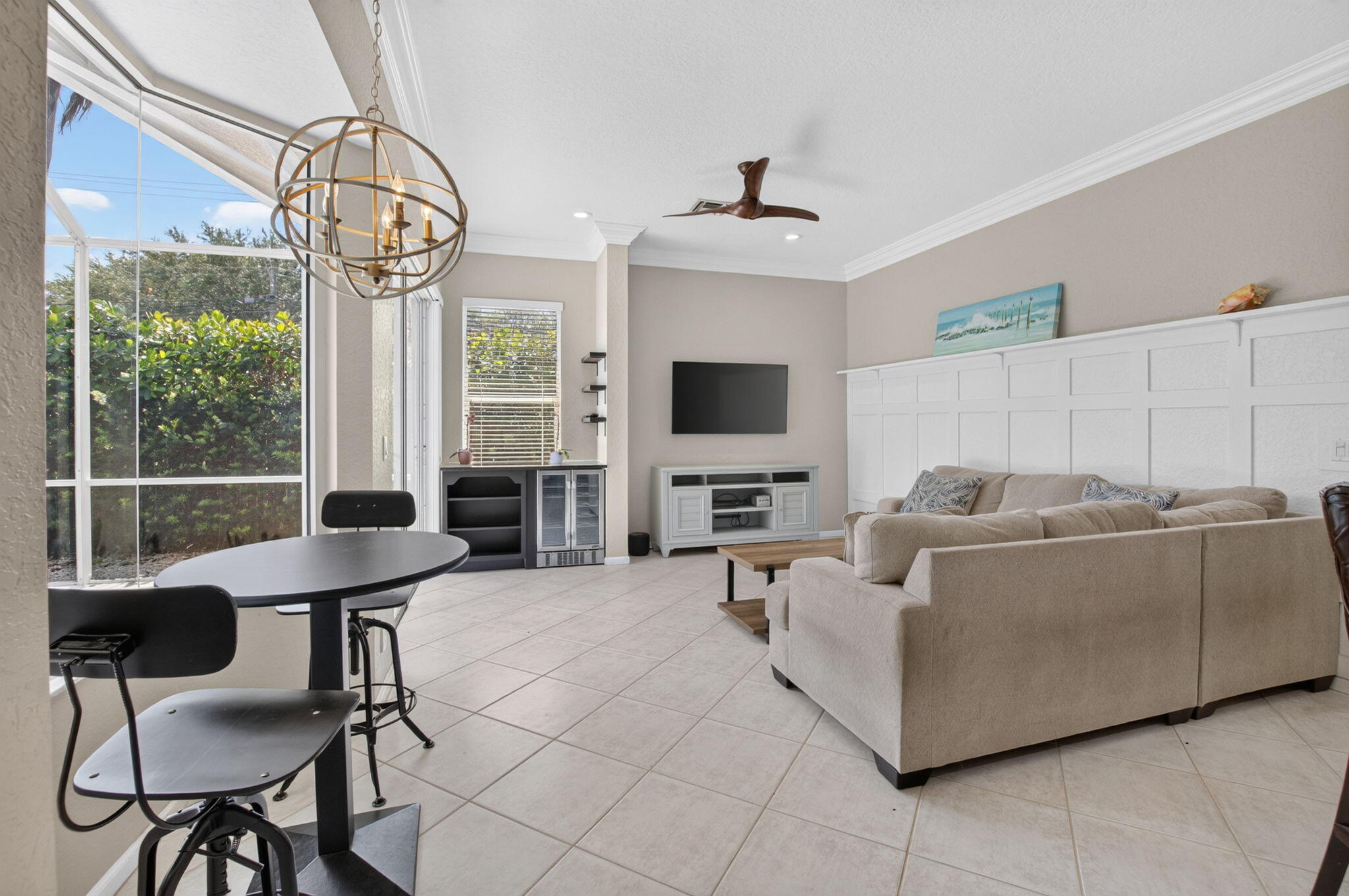 1365 East Barwick Ranch Circle Delray Beach, FL 33445 - Photo 40 of 77 a living room with furniture a flat screen tv and a large window